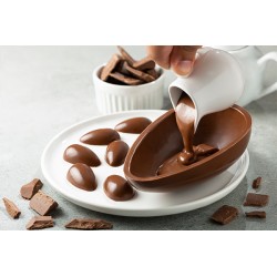 chocolat au lait 35% de cacao versé dans un moule pour confection d’œufs et pralines, utilisé pour pâtisserie gourmande.